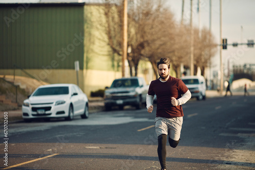 Determined man jogging on a city street