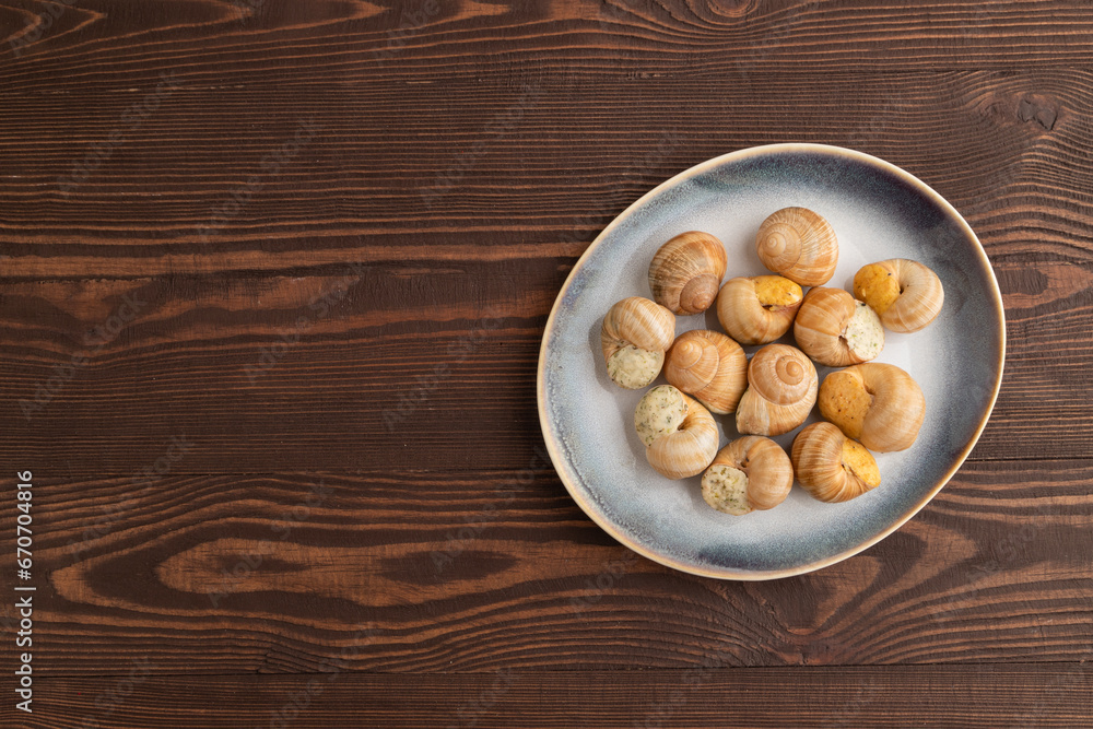 Grape (Burgundy) snails with butter and cheese on brown wooden, top view, copy space. Grape (Burgundy) snails with butter and cheese on brown wooden, top view, copy space.