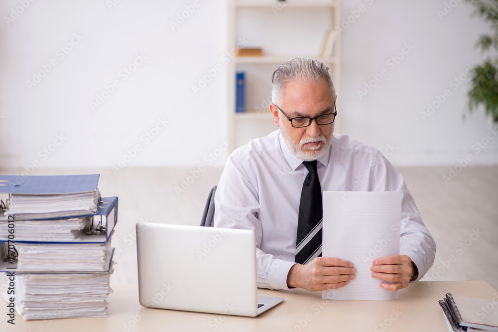 Old male employee and too much work in the office Old male employee and too much work in the office