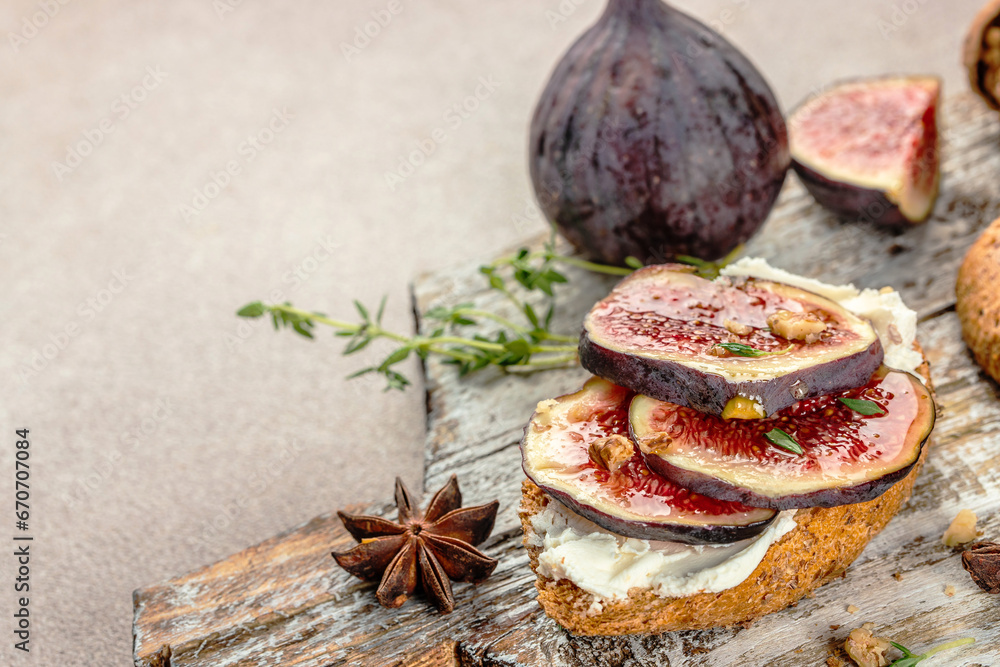 Figs fruit toast with honey and walnut on plate. Food recipe background. Close up