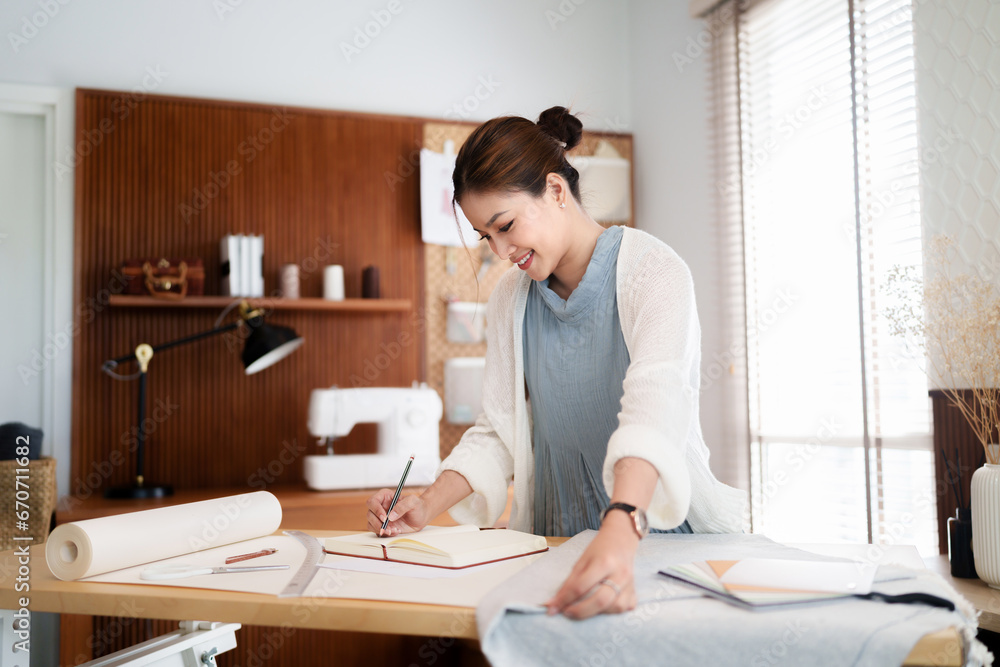 Fashion seamstress woman use tape measure to measuring textile garment pattern for fashion clothes. Fashion seamstress woman use tape measure to measuring textile garment pattern for fashion clothes.