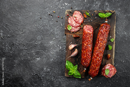 Salami sausage slices on a wooden board. banner, menu, recipe place for text, top view photo