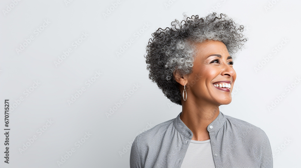Obraz premium Beautiful aged mature woman with short gray hair and happy smile on a white background with copy space
