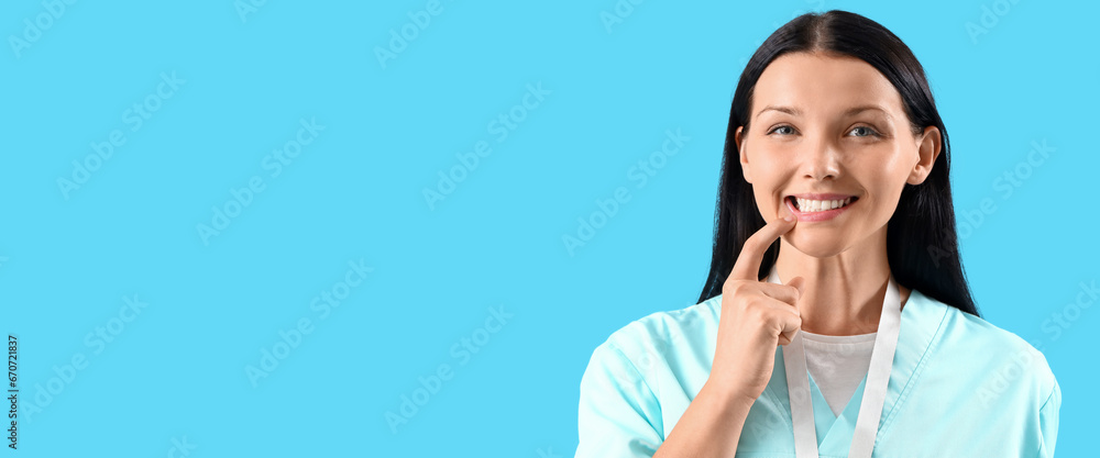 Smiling female dentist on light blue background with space for text Smiling female dentist on light blue background with space for text