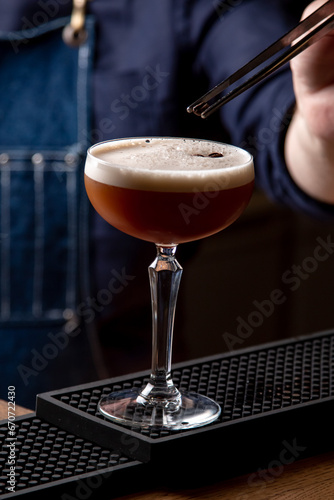 Bartender preparing a cocktail in a restaurant, close-up