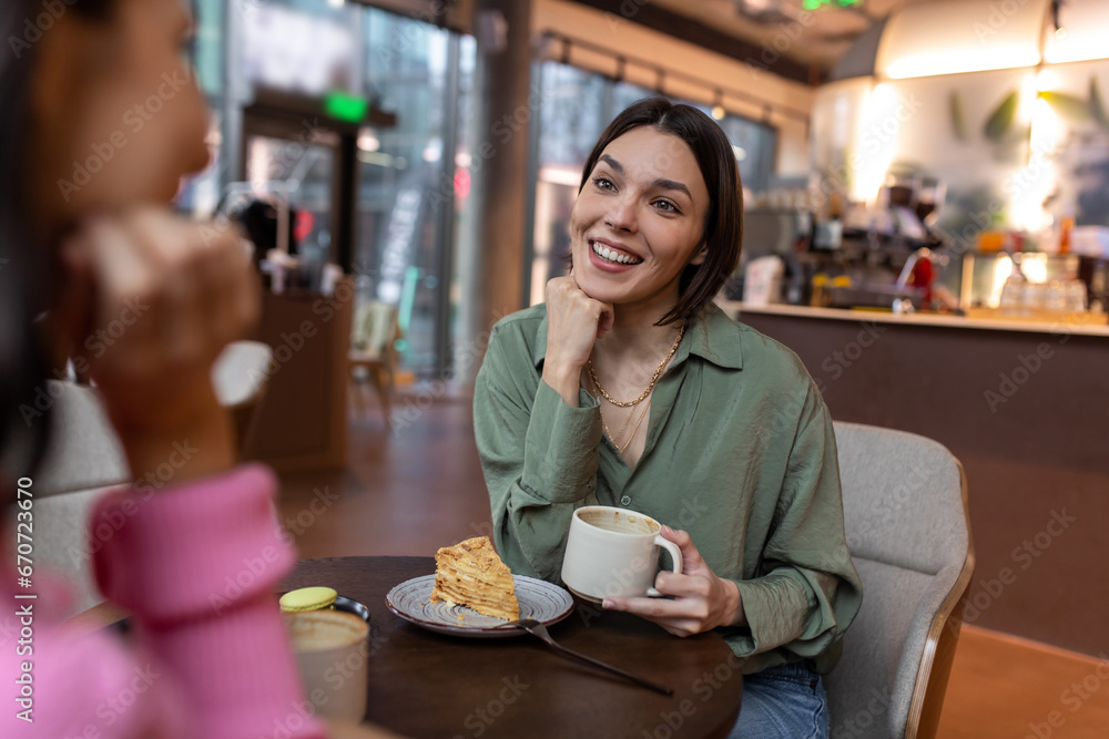 Two friends talking in a cafe and looking involved Two friends talking in a cafe and looking involved