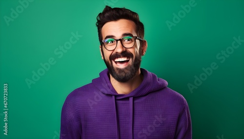 Excited man in purple hoodie on green background