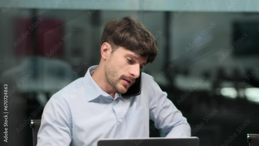 Serious man manage dual tasks, conversing intently on the phone while sorting papers in office. Concentrated expression and swift movements underline commitment to both communication and organization. Serious man manage dual tasks, conversing intently on the phone while sorting papers in office. Concentrated expression and swift movements underline commitment to both communication and organization.