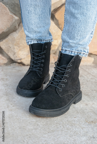 Winter boots on women's feet. Stylish youth shoes.