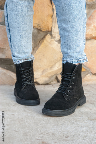 Winter boots on women's feet. Stylish youth shoes.