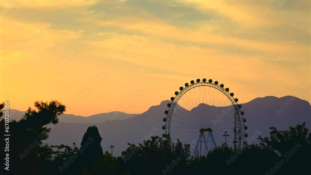Big Ferris wheel in the amusement park at sunset in Konyaalti Antalya