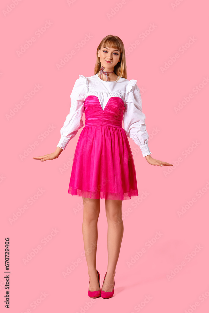 Young woman dressed as doll on pink background Young woman dressed as doll on pink background
