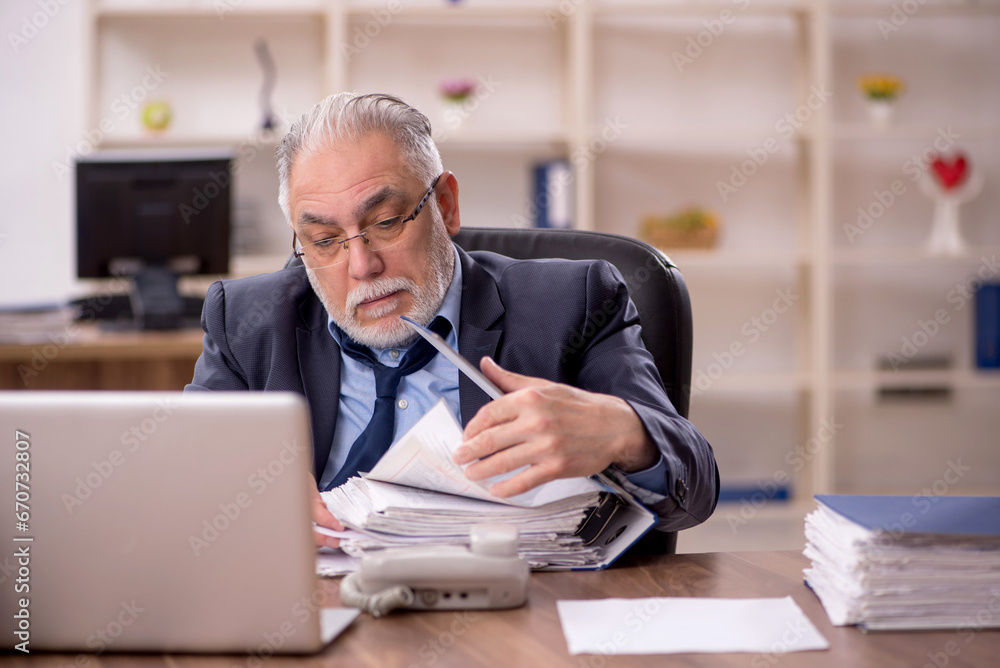 Old male employee and too much work in the office Old male employee and too much work in the office