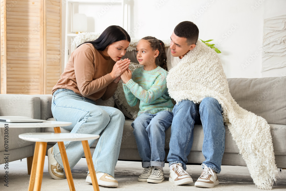 Frozen family with lack of heating warming hands at home Frozen family with lack of heating warming hands at home