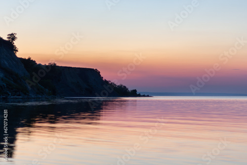 purple sunset on the river bank in summer