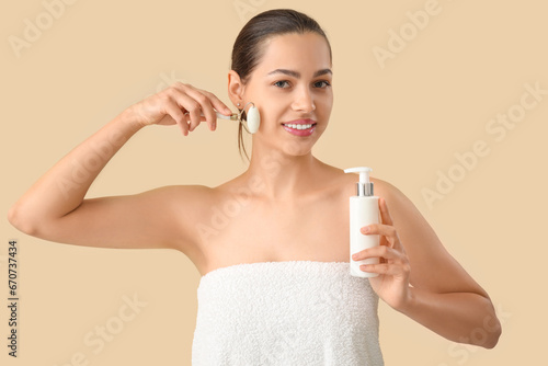 Young woman using jade roll...