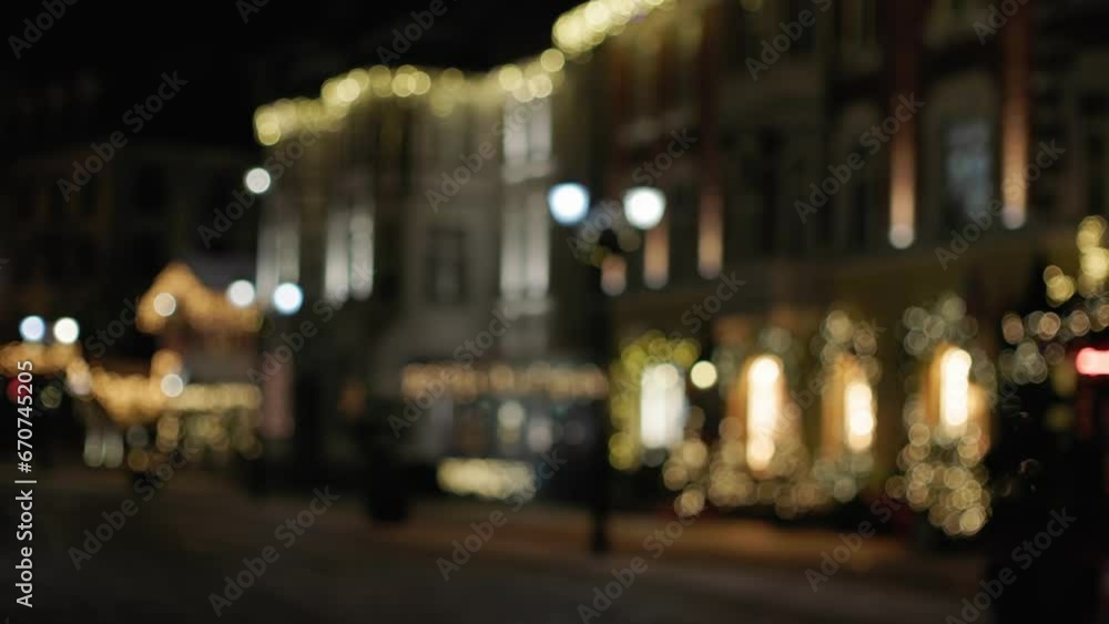 blurred defocused Christmas downtown city center. Christmas decorated Town at Night, Festively Decorated and Illuminated bokeh atmosphere of winter holidays outdoors. Christmas golden dark brown blurred defocused Christmas downtown city center. Christmas decorated Town at Night, Festively Decorated and Illuminated bokeh atmosphere of winter holidays outdoors. Christmas golden dark brown