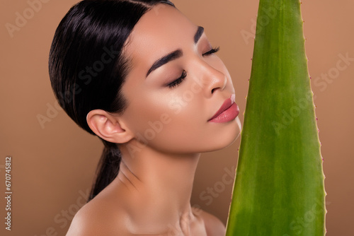 Photo of adorable lady herbal cosmetics green fresh aloe leaf natural cream lotion isolated on beige color background