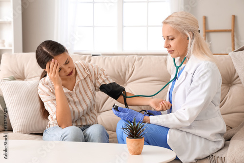 Female doctor measuring blo...