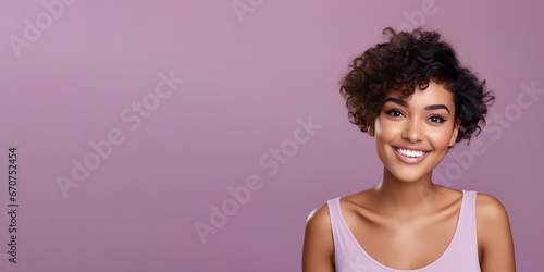 Smimilg young woman with dark skin and short groomed hair isolated on flat violet pastel background with copy space. Model for banner of cosmetic products, beauty salon and dentistry