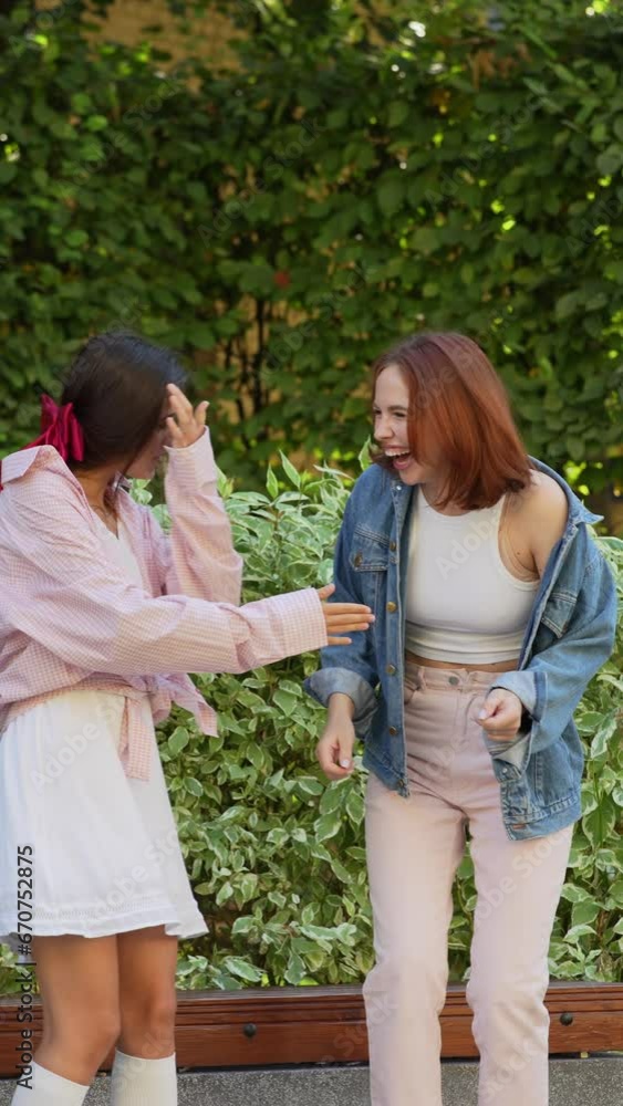 On a summer day, two attractive companions are having a joyful time on the street. On a summer day, two attractive companions are having a joyful time on the street.