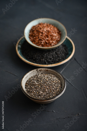 Black sesame  flax and chia seeds in ceramic plates