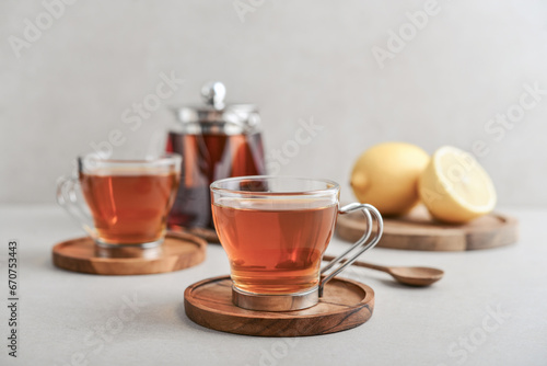 Tea in a glass cups with lemon on cutting board