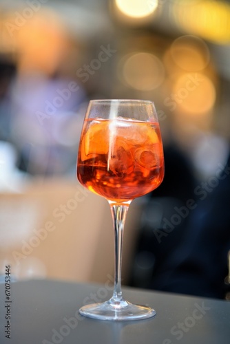 Vibrant glass of alcohol positioned on a tabletop in a restaurant setting