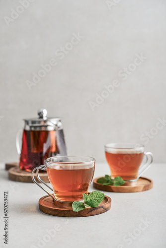 Tea  in a glass cups with  glass teapot
