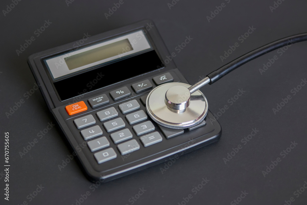 Stethoscope on calculator representing healthcare costs