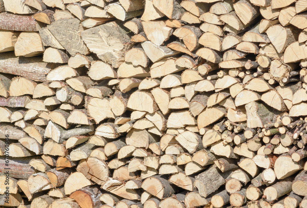 Stacked firewood in a woodpile Stacked firewood in a woodpile
