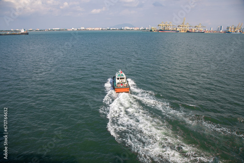 Pilot Boat in the Harbor of Penang, Malaysia Returning to Shore After Guiding Cruise Ship 