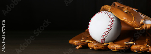 Canvas Print Leather baseball glove with ball on wooden table, space for text
