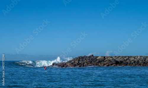 Tip of an Island with Waves Breaking and a Warning Flag Alerting Boaters that there are Divers Below. © ttrimmer