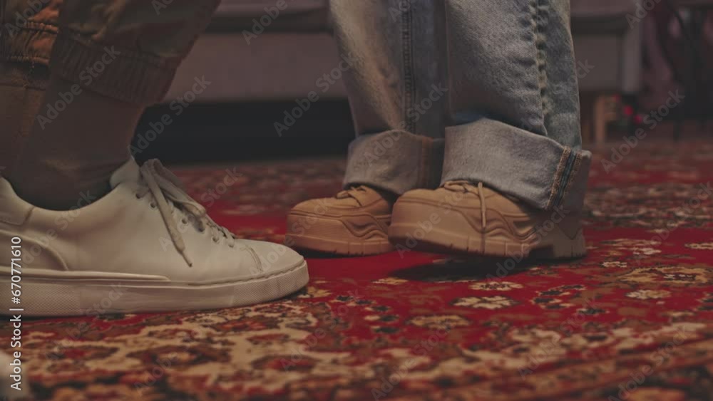 Low section close up shot of legs of two musicians tapping their feet while playing music at studio Low section close up shot of legs of two musicians tapping their feet while playing music at studio