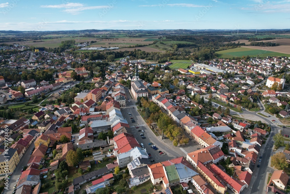 Obraz premium Polna historical city center of Bohemian town with square,column and cathedral and Polna castle,aerial panorama landscape view,Czech republic,Europe