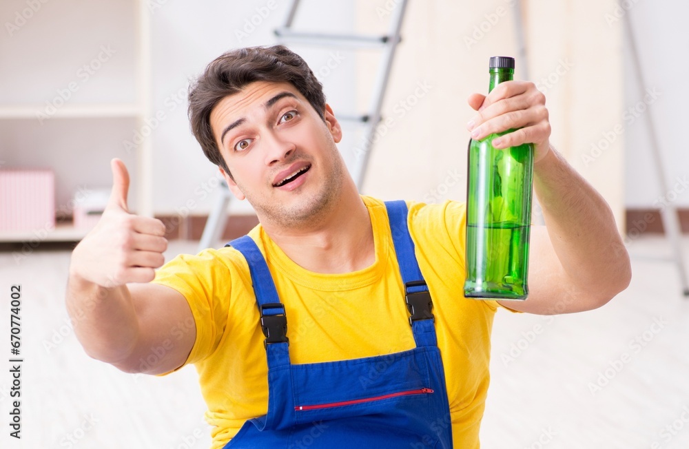 Floor repairman drinking alcohol during break Floor repairman drinking alcohol during break