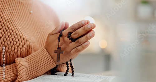 Closeup hands, rosary and a bible for prayer, spiritual support and hope from Jesus. House, God and a person with a cross and book for help, trust and gratitude as a Christian for the gospel