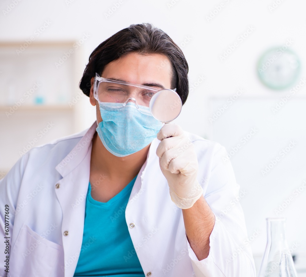 Young male chemist working in the lab Young male chemist working in the lab