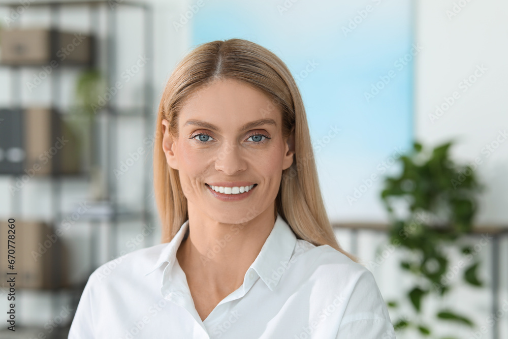 Portrait of smiling woman in formal clothes. Charming blonde lady posing indoors Portrait of smiling woman in formal clothes. Charming blonde lady posing indoors