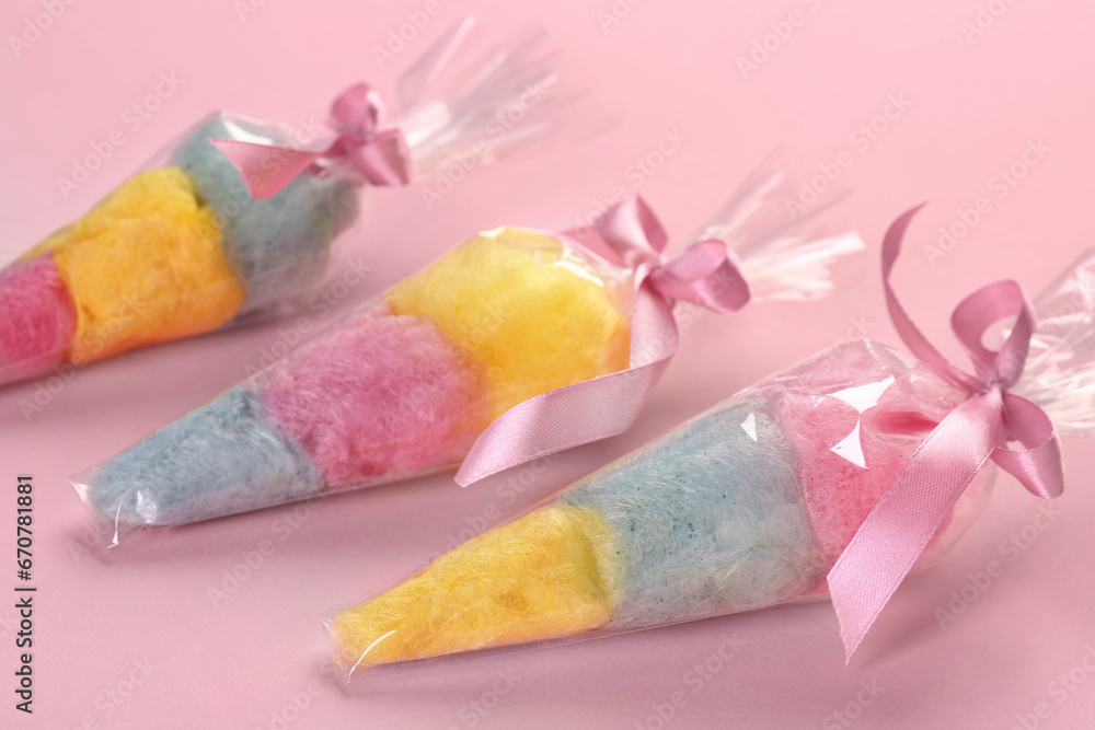 Packaged sweet cotton candies on pink background Packaged sweet cotton candies on pink background