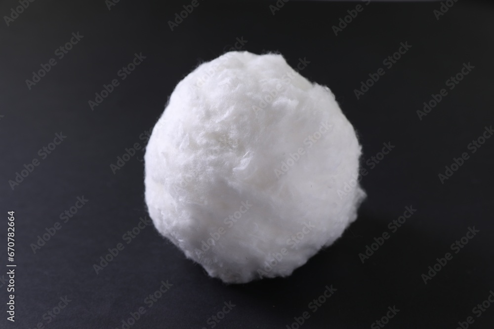 Ball of clean cotton wool on dark background, closeup