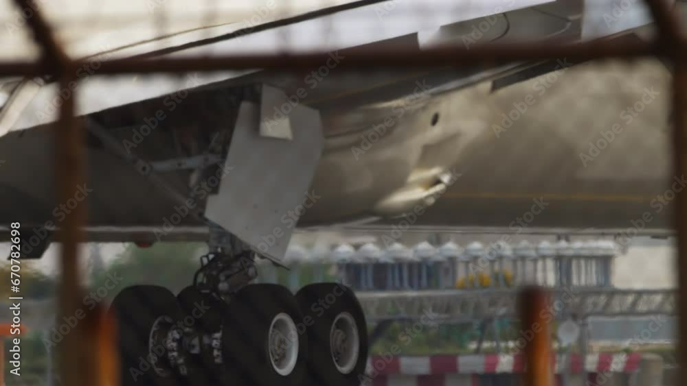 Jet engine of airplane. Aircraft view through airport fence. Plane on the runway preparing for takeoff Jet engine of airplane. Aircraft view through airport fence. Plane on the runway preparing for takeoff