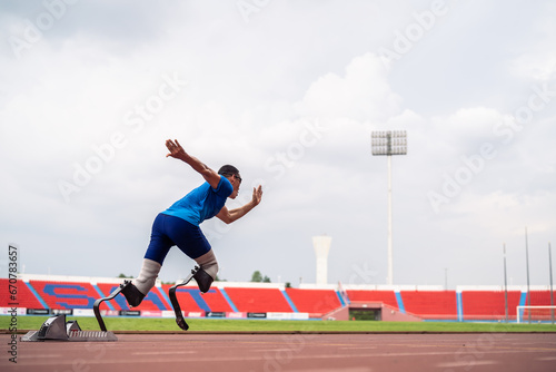 Asian athletes are disabled with prosthetic blades running at stadium.  © Kawee