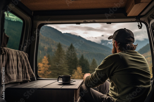 A person has a rest in his camper car with beautiful view on nature