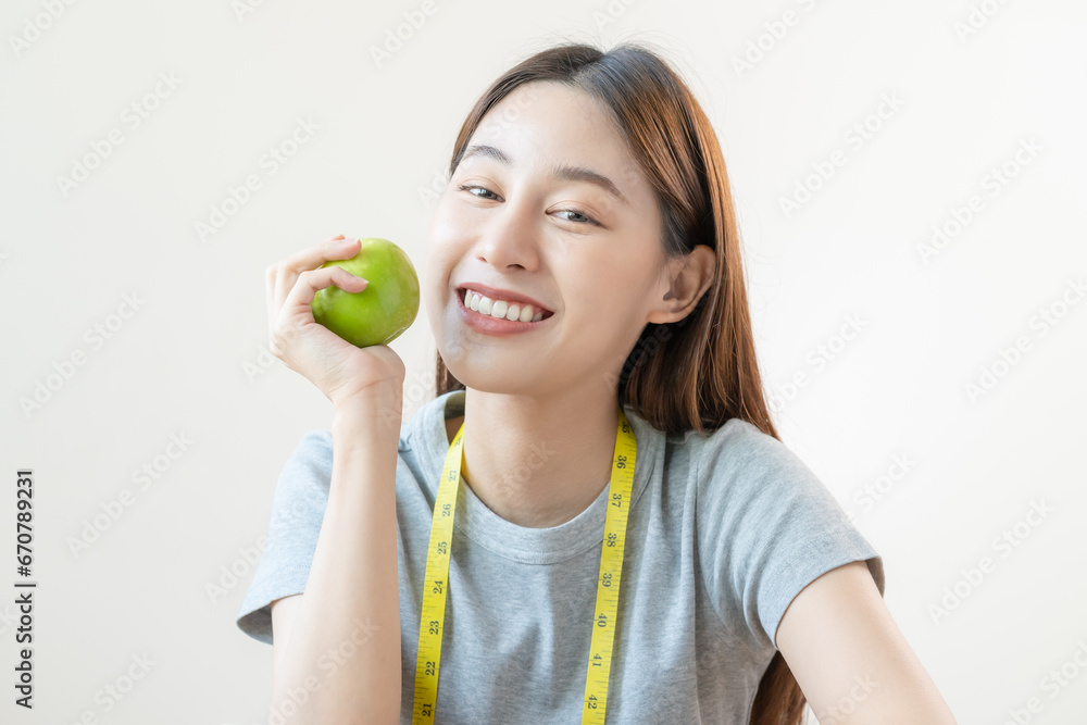 Diet food concept, Close up portrait smile, cheerful asian young woman, girl with healthy teeth, hand holding or eating organic fresh green apple when hungry, isolated on white background healthcare. Diet food concept, Close up portrait smile, cheerful asian young woman, girl with healthy teeth, hand holding or eating organic fresh green apple when hungry, isolated on white background healthcare.
