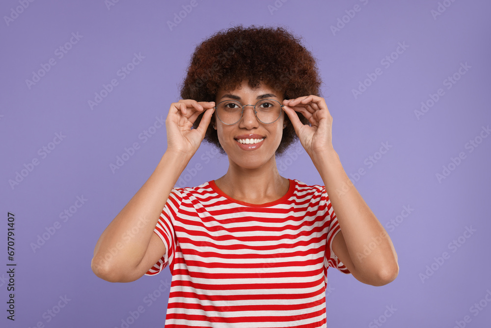 Portrait of happy young woman in eyeglasses on purple background Portrait of happy young woman in eyeglasses on purple background
