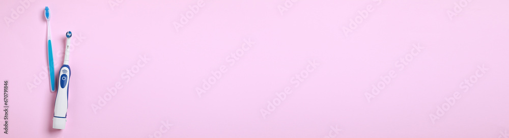 Electric and plastic toothbrushes on pink background, top view. Banner design with space for text Electric and plastic toothbrushes on pink background, top view. Banner design with space for text