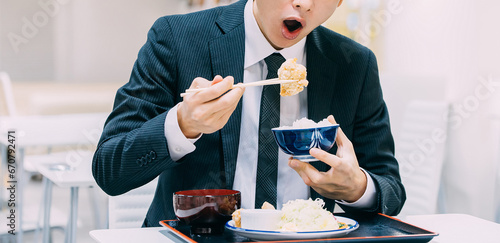 定食を食べる日本人男性ビジネスマン photo