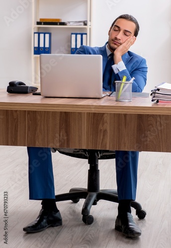 Young male businessman employee working in the office